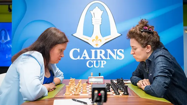 Cairns Cup players at chessboard